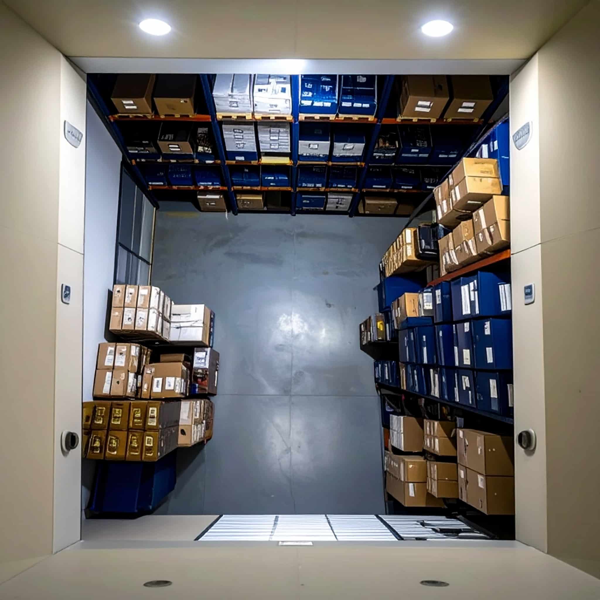 Storage unit at All Access Storage Parksville organized with shelves and boxes to show storage capacity.